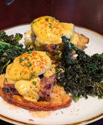 Delilah's signature dishes Pork Belly BennyNashville Hot ChickenCajun Shrimp